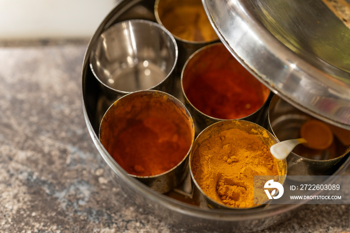 Dried spices in small bowls on kitchen counter