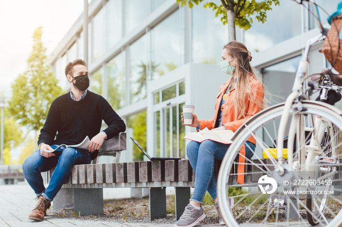 Students on university campus keeping social distance due to coronavirus