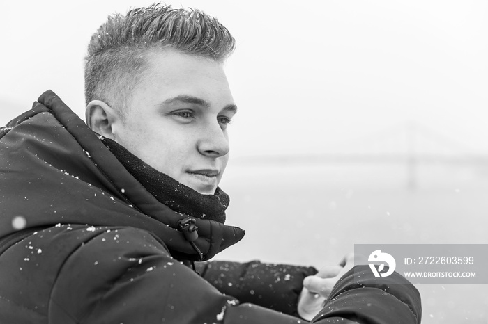 Portrait of young blonde guy Nordic appearance, lifestyle of young people. Handsome guy close up, winter day thinking about something