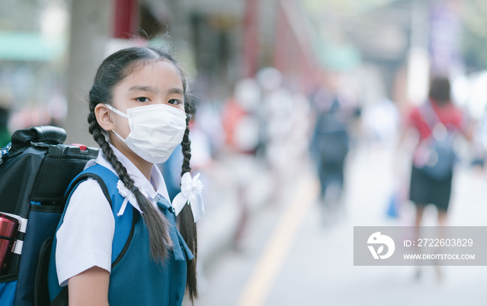 School Girl wearing mouth mask against air smog pollution in Bangkok city, Thailand