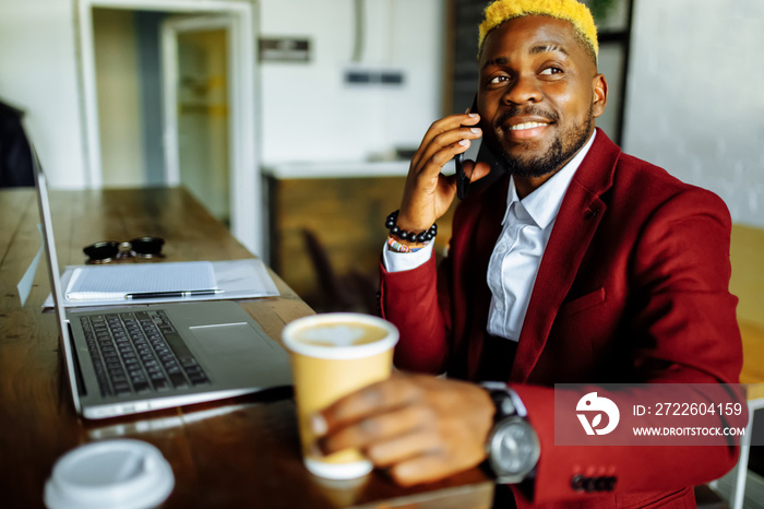 cheerful businessman entrepreneur talking mobile phone and writing note at office