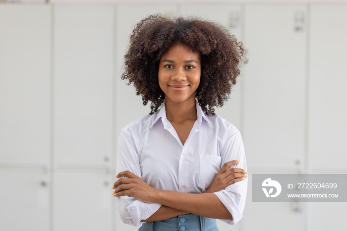 Female african american business woman in at the workplace, standing confidently. Attractive young businesswoman with a happy smile.