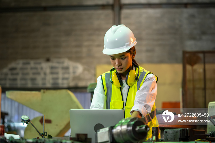 Industry worker woman under inspection and checking production at factory by laptop.