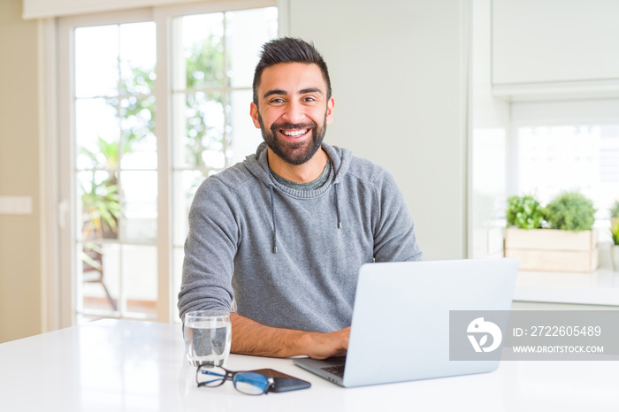 Man smiling working using computer laptop