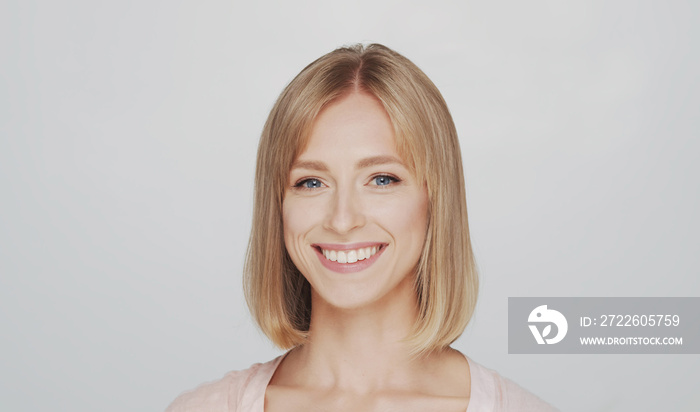 Studio portrait of young, beautiful and natural blond woman.