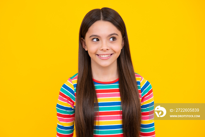 Happy face, positive and smiling emotions of teenager girl. Children studio portrait on yellow background. Childhood lifestyle concept. Cute teenage girl face close up.