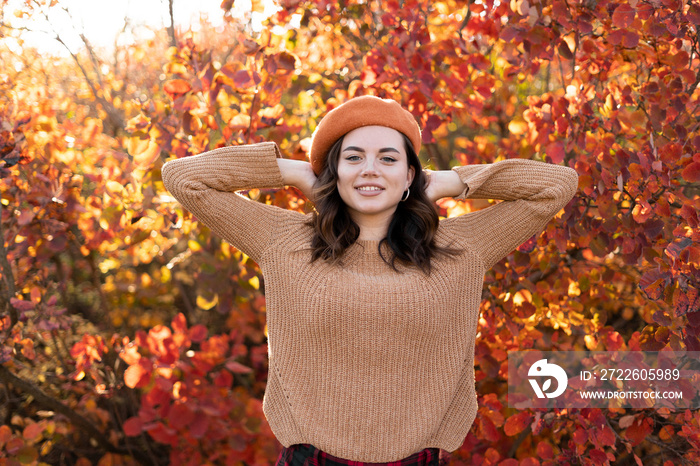 Attractive woman in autumn park. Warm sunny weather. Fall concept.