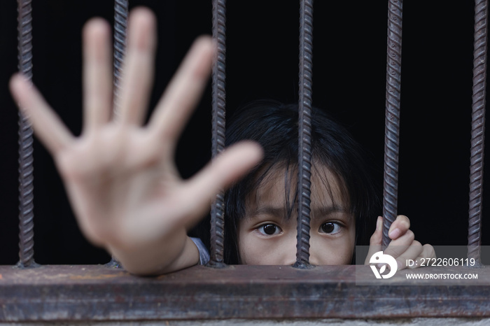 little girl hold cage with eye sad and hopeless, Human trafficking concept, human rights violations, Stop violence and abused children. traumatized children concept.