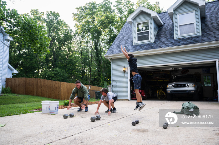 Air Force service member trains with his sons in a morning workout in preperation for a PT fitness test.