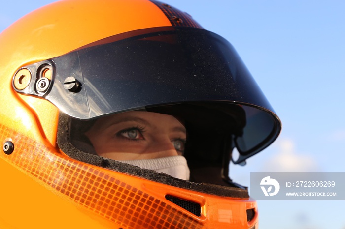 Female race car driver wears helmet and balaclava