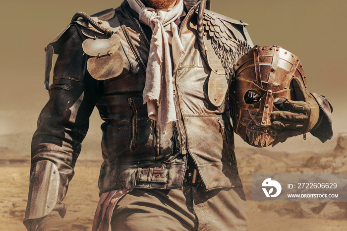 Photo of a post apocalyptic raider warrior torso in leather jacket with metal armor standing in wasteland with steel mask.