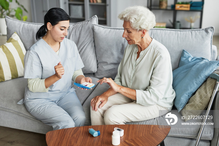 Portrait of female nurse consulting senior woman in retirement home, copy space