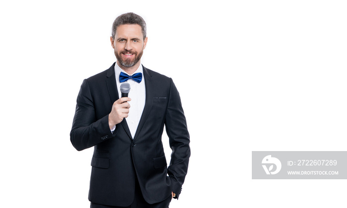 man presenter wear tuxedo in studio with copy space. presenter man speaking in microphone.