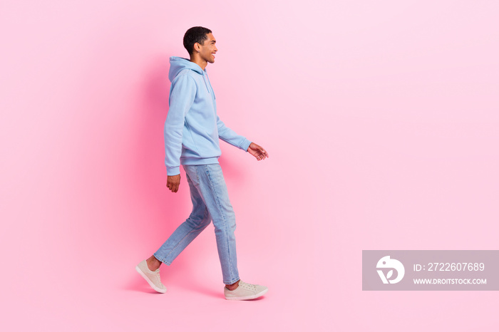 Profile side photo of cheerful successful man wear comfort clothes moving empty space store mall center isolated on pink color background
