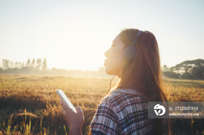 young hipster  beautiful girl listening to music, mobile phone,