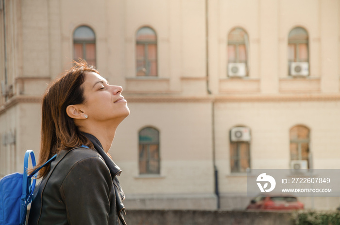 Young woman enjoying spring sun with her eyes closed