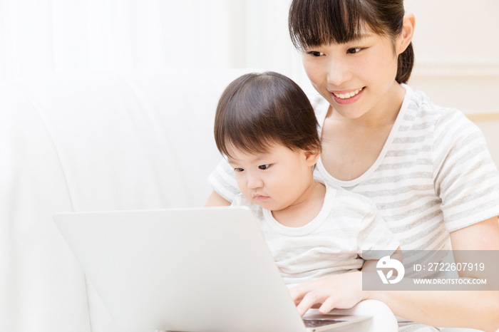 asian baby and mother using laptop