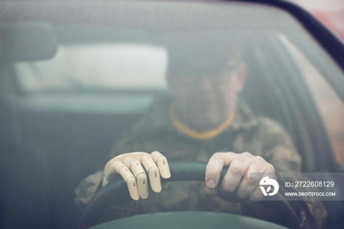 war veteran driving a car with prosthetic hand