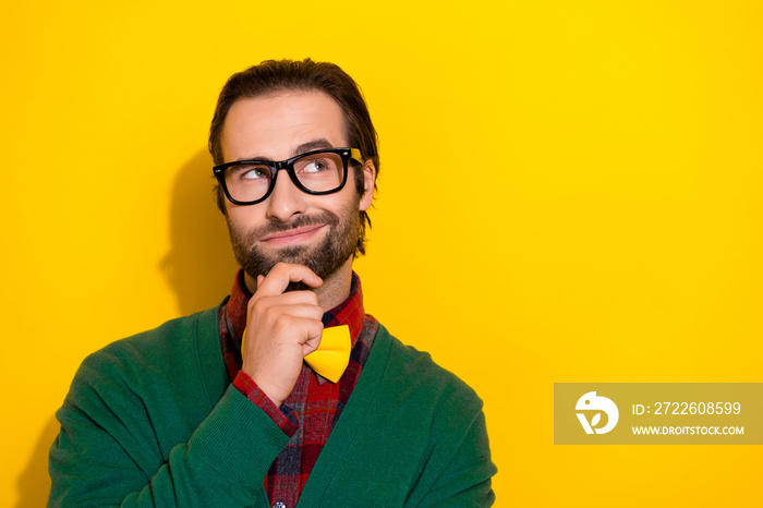 Photo portrait of young handsome man eyewear touch chin creative plan idea wear trendy green outfit isolated on yellow color background