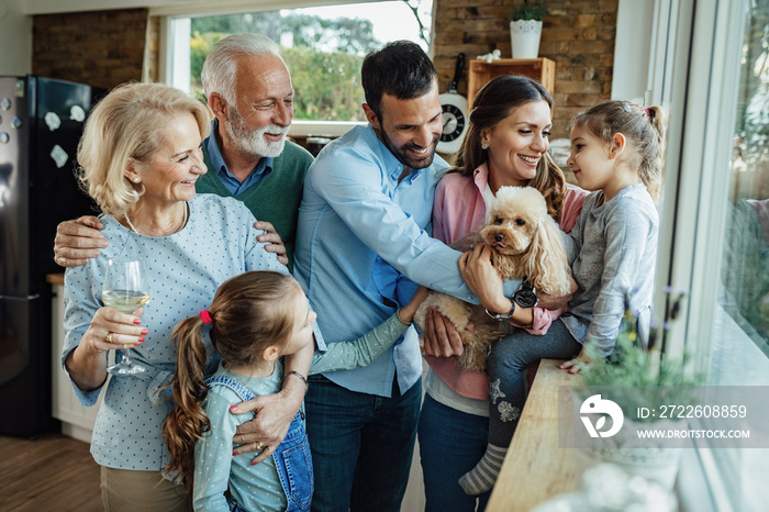 Happy multi-generation family with a dog having fun at home.