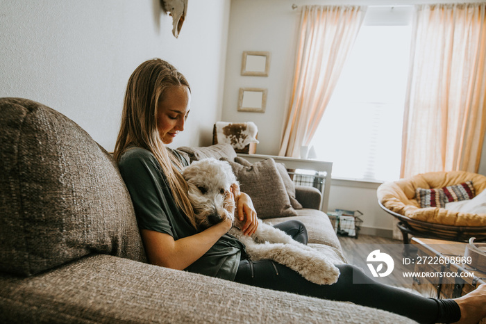 Girl with her dog at home