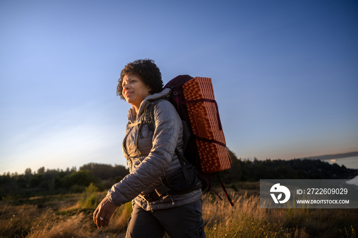 U.S. Army female soldier putting in the miles with an early morning hike in the NorthWest.