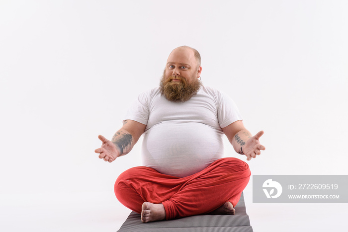 Man sitting on a yoga mat