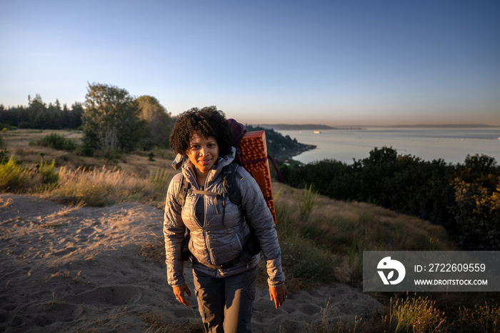 U.S. Army female soldier putting in the miles with an early morning hike in the NorthWest.