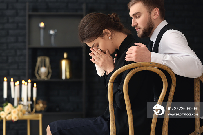 Couple pining after their relative at funeral