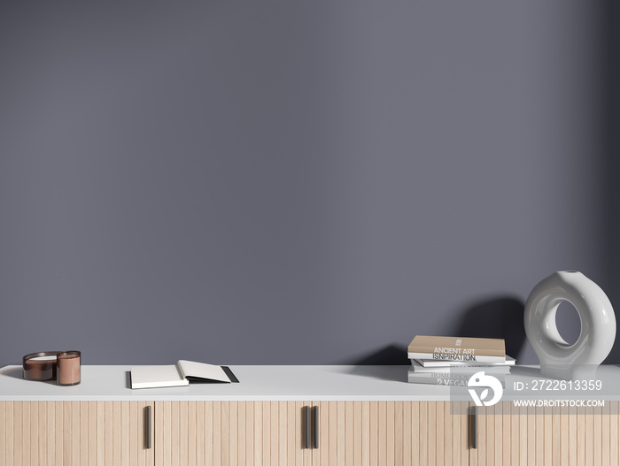 Books on white and wooden cabinet in grey room