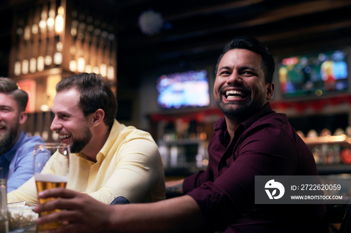 Men watching american football in the pub