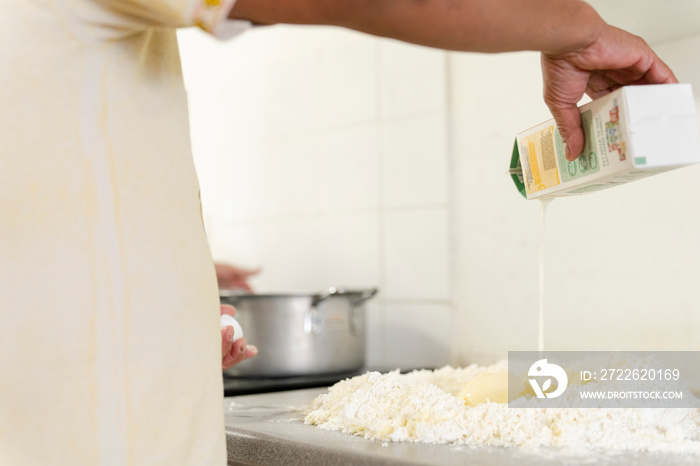 Midsection of man preparing dough