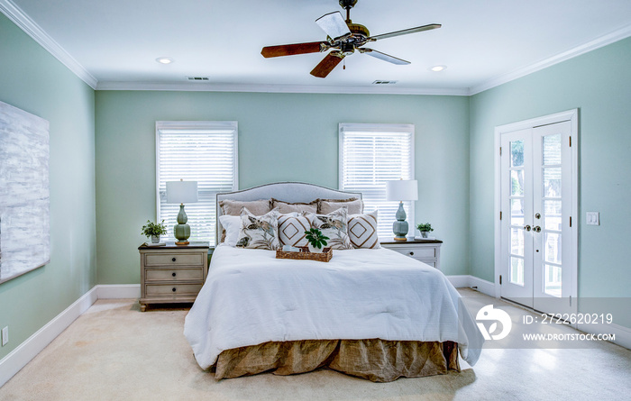 Beautiful master bedroom with windows and glass doors