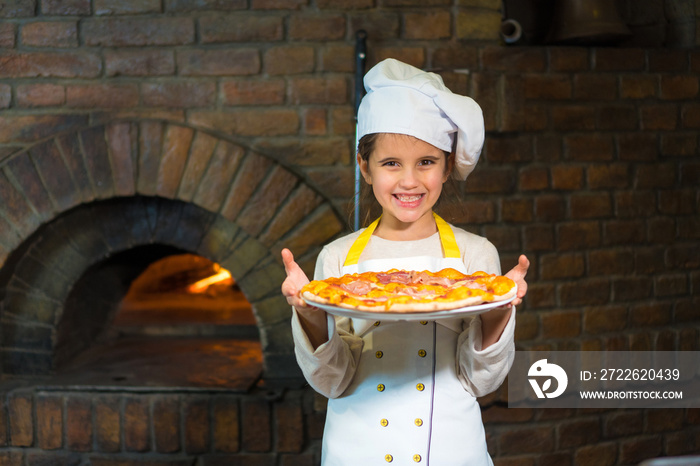 Cheerful young little girl with a pizza