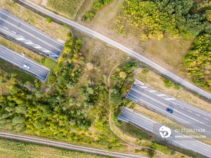 Aerial view of wildlife overpass over highway in Switzerland during sunset