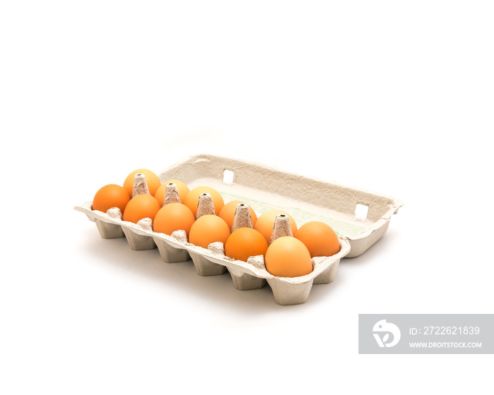 Close-up an open carton box of a dozen fresh cage free grade A large brown eggs isolated on white background. Top view dozen eggs in cardboard container, paper egg box with clipping path, copy space.