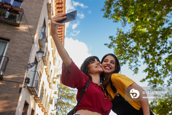 Two teenager girls taking a selfie.