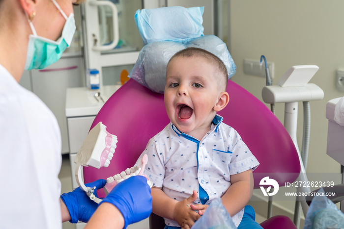 Little boy showing his teeth to a doctor