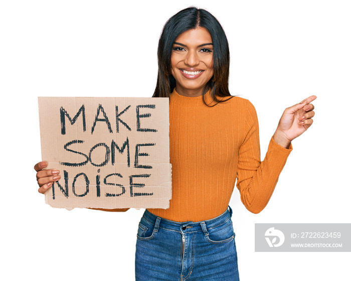 Young latin transsexual transgender woman holding make some noise banner smiling happy pointing with hand and finger to the side