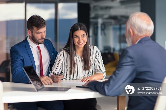 Young couple meeting financial advisor for home investment