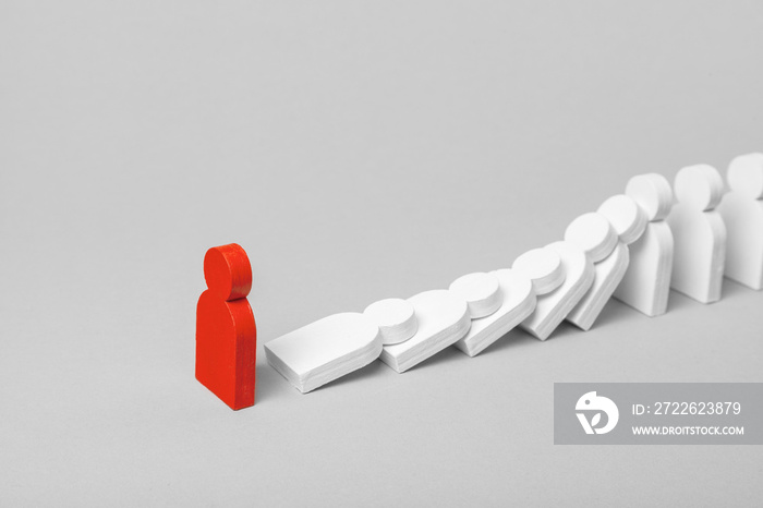 Concept of domino effect in business. The fall of the crumbling business starts with one bad employee leader. The domino line of the white figures of the man is falling from behind the red little man