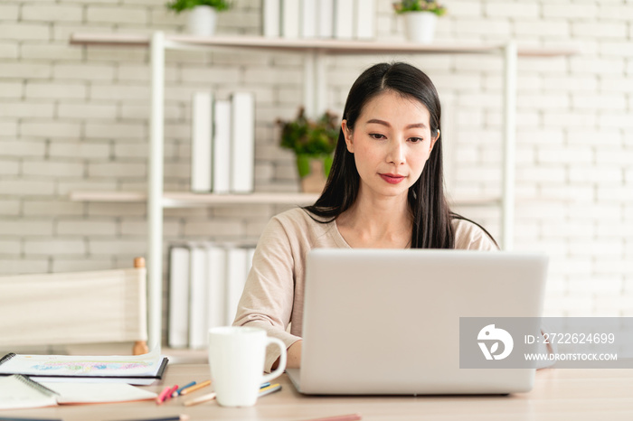 Beautiful young Asian woman wear surgical mask working from home and feeling happy smiling with joyful expression