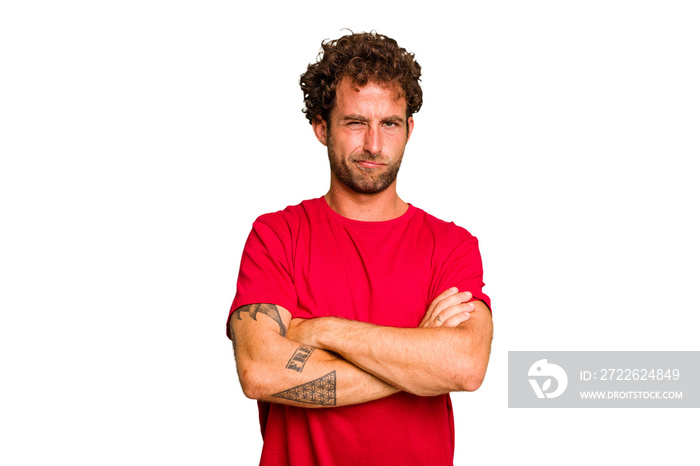 Young caucasian curly hair man isolated Young caucasian man with curly hair isolated frowning face in displeasure, keeps arms folded.