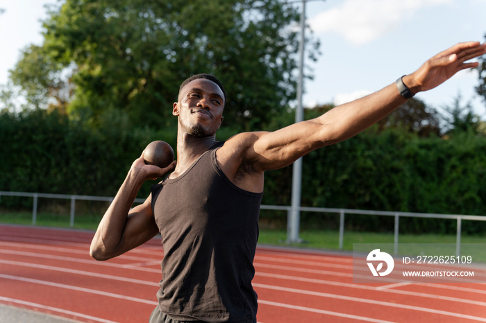 Portrait of shot putter preparing to throw