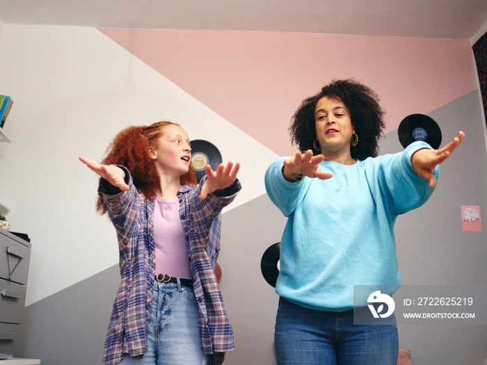 Mother and daughter  dancing in room