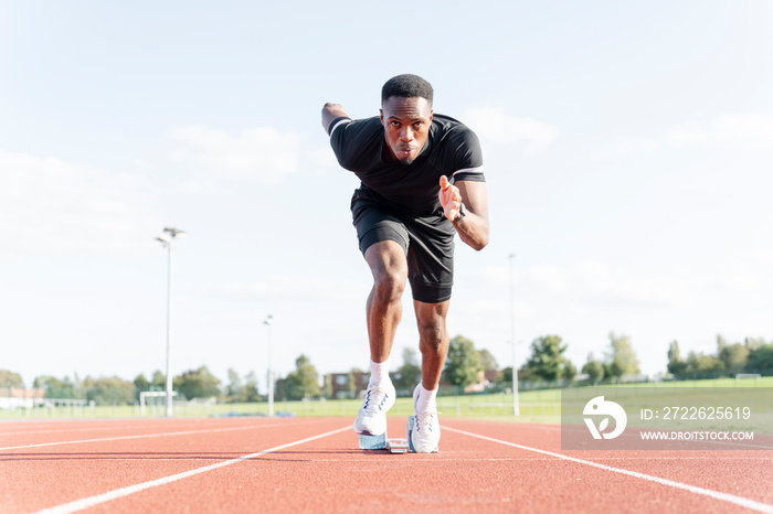 Athlete sprinting off at running track