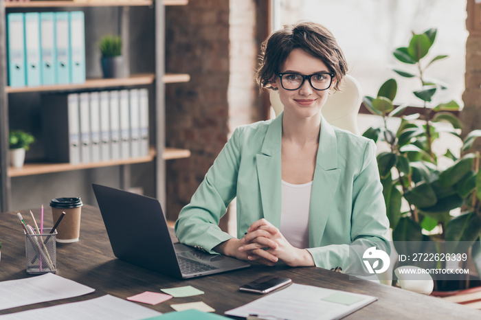 Portrait of independent start up development trainer coach girl sit table desk ready solve work decisions consult clients partners wear blazer jacket in workstation