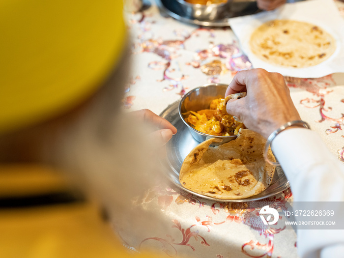 Man eating traditional Indian food at home