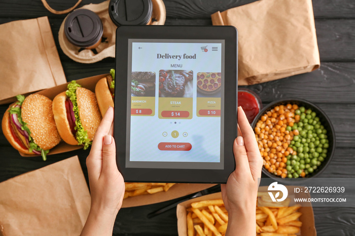 Woman with tablet computer ordering food online