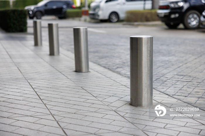 stainless steel bollards on footpath near car park lot. metal barrier pillars.